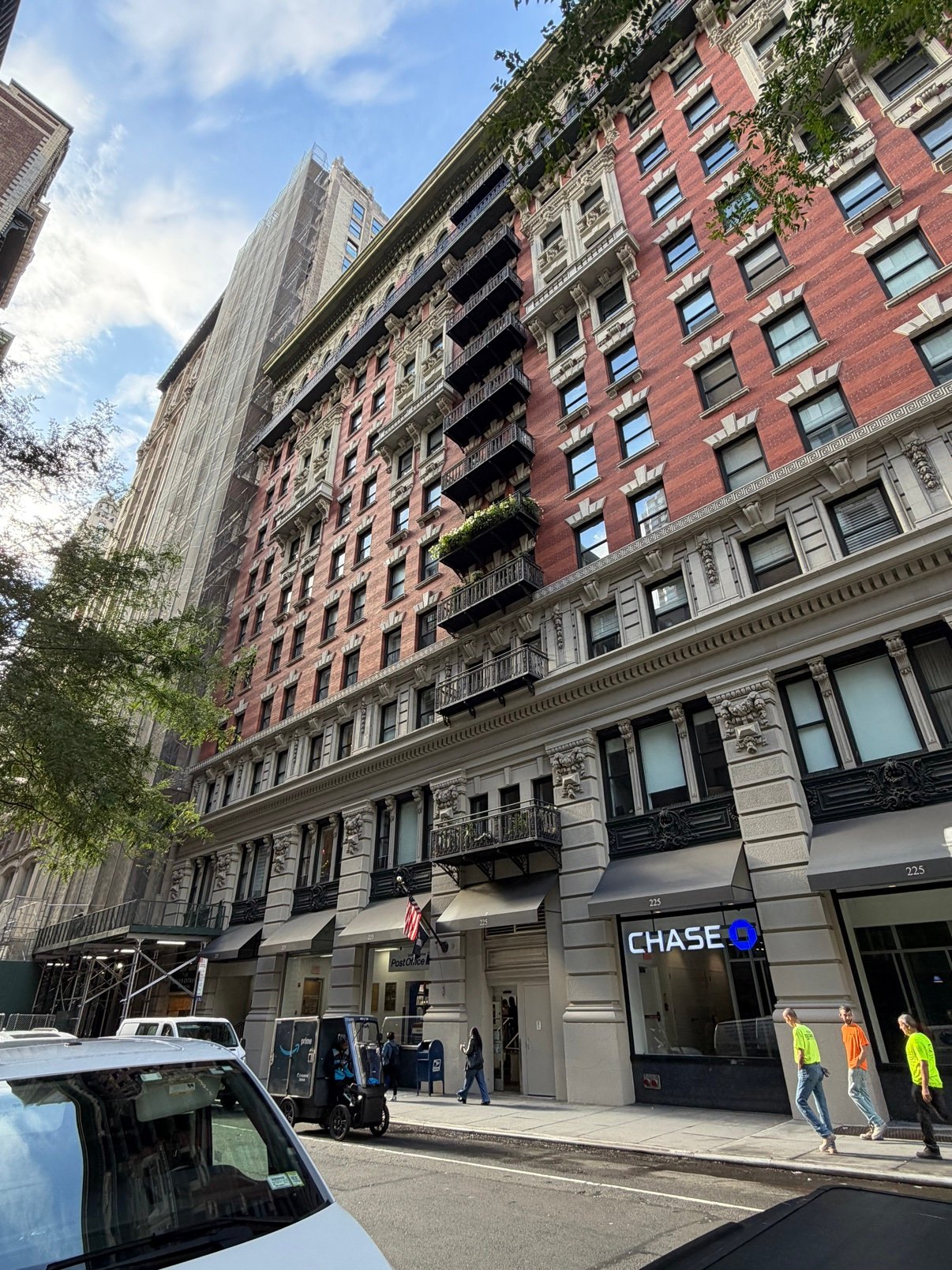 Manhattan street view of a brick building with a Chase bank and post office at street level